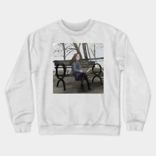 Young Woman on a Bench on a Cloudy Day Crewneck Sweatshirt